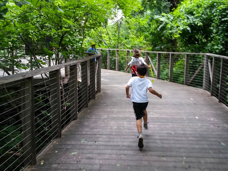 Children running through Native Texas Boardwalk
