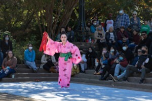 Woman in pink kimono performs a traditional dance at the Japanese Festival