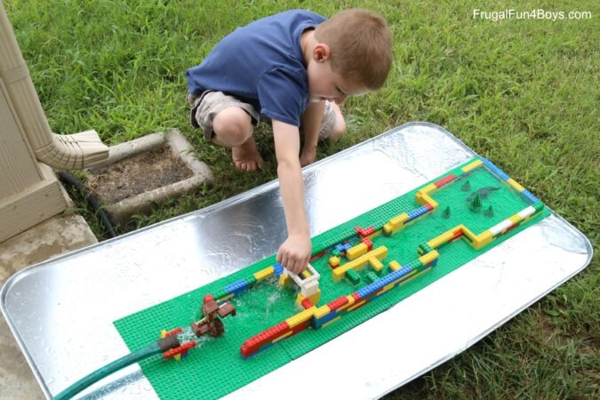Child playing with a DIY water course