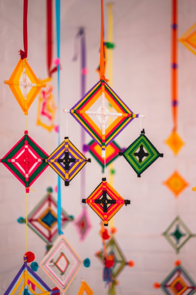 Ojo de dios or God's Eyes woven crafts in bright oranges and reds
