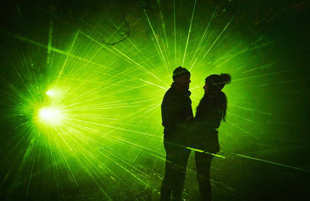 Lightscape 2023 Couple in front of green laser lights