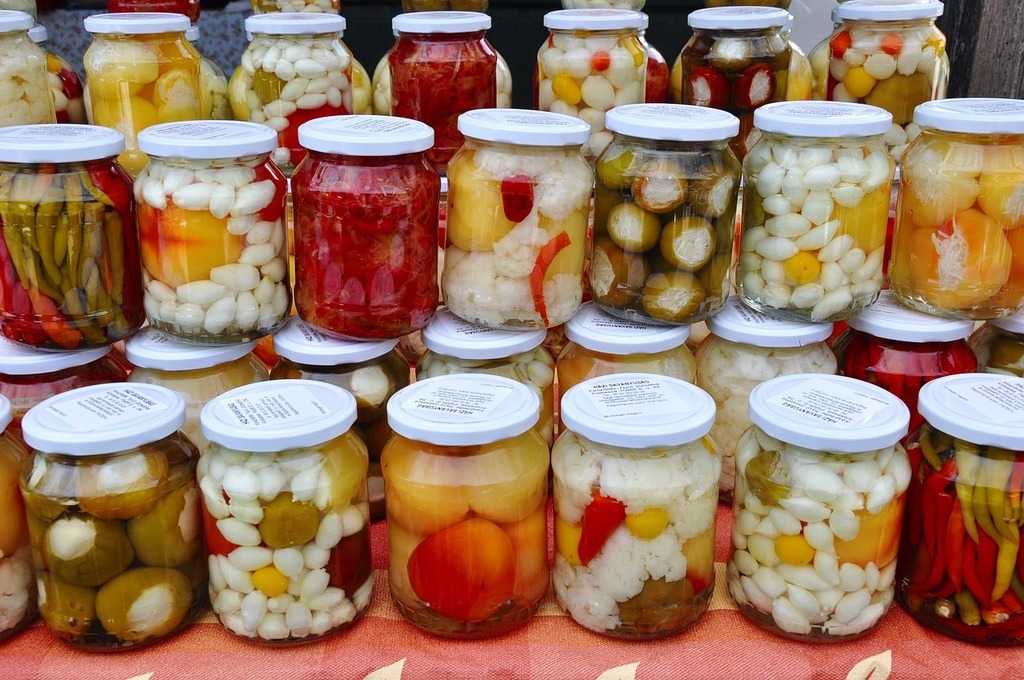 Jars of colorful preserved vegetables.