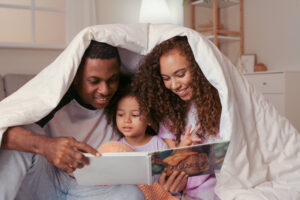 Mom and Dad read with their daughter
