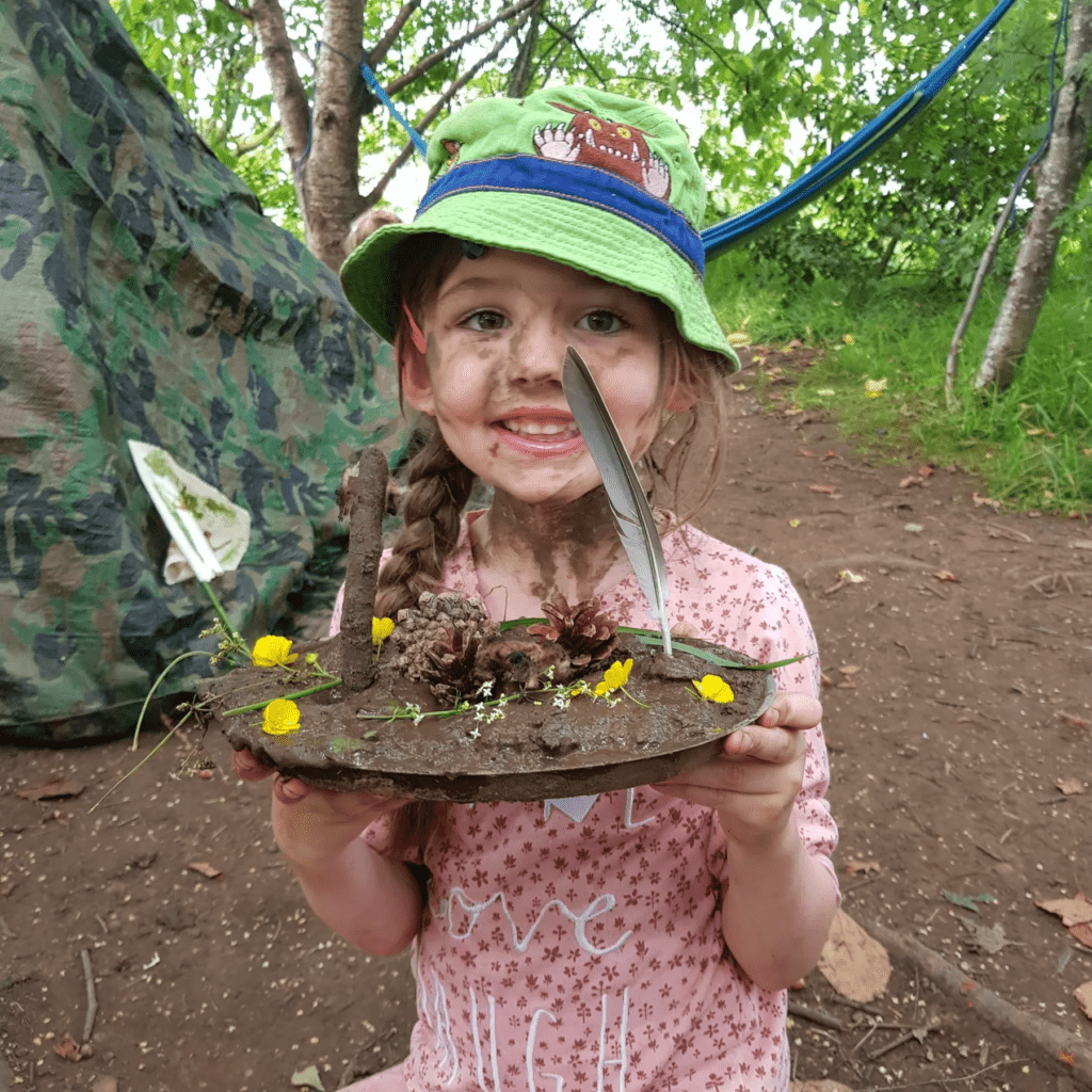 Little girl playing in mud
