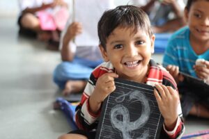Little boy smiling with school notebook